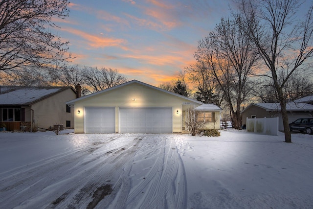 ranch-style house featuring an outbuilding and a garage