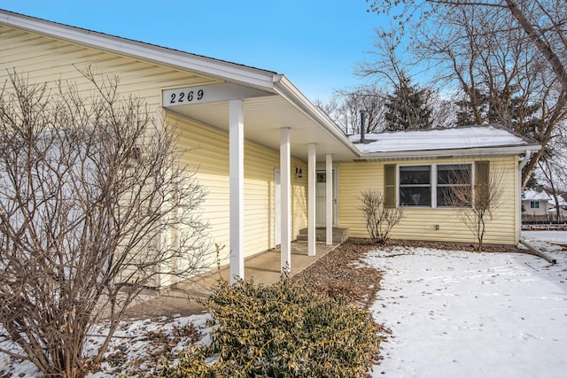 view of snow covered property entrance