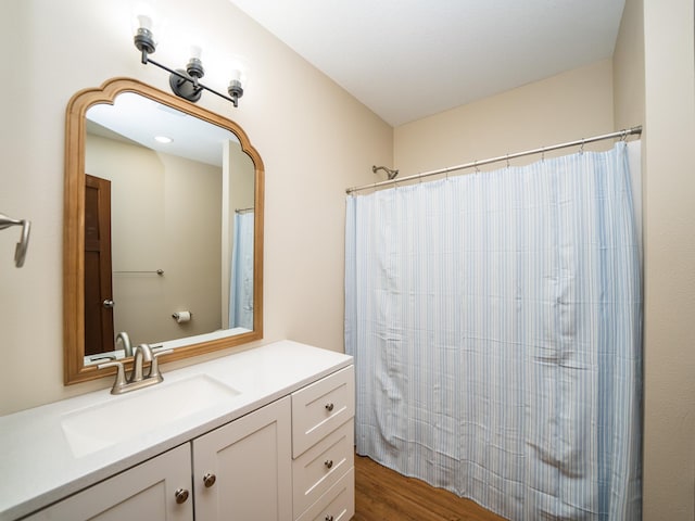 bathroom featuring vanity, curtained shower, and wood-type flooring