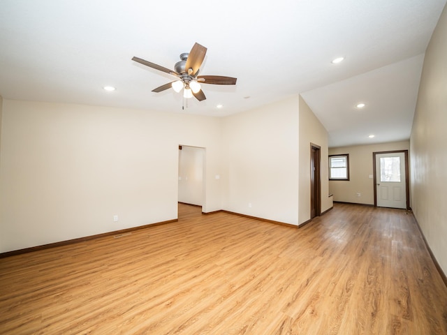 spare room with ceiling fan, lofted ceiling, and light hardwood / wood-style flooring