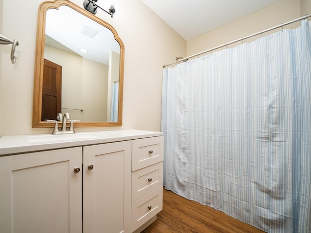 bathroom featuring hardwood / wood-style flooring and vanity