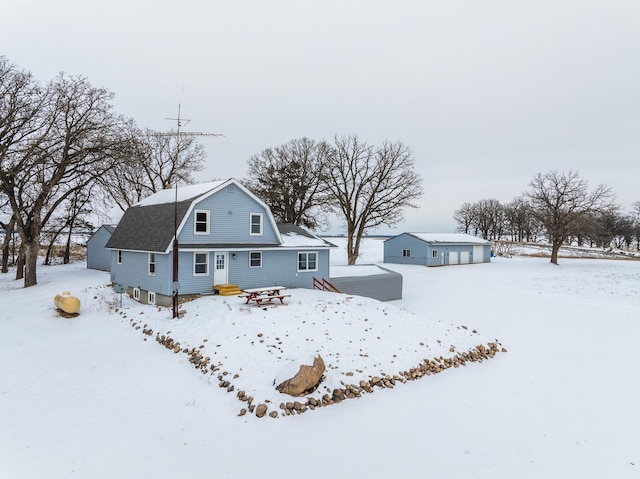 view of snow covered back of property