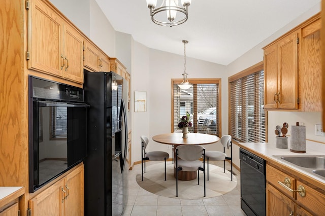 kitchen with lofted ceiling, light tile patterned floors, sink, hanging light fixtures, and black appliances