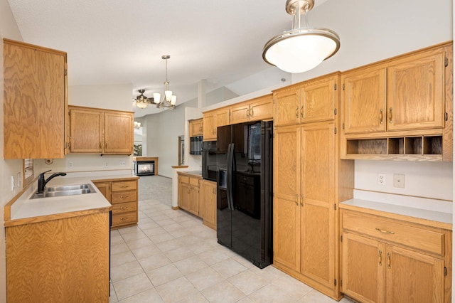 kitchen featuring vaulted ceiling, pendant lighting, sink, a chandelier, and black refrigerator with ice dispenser