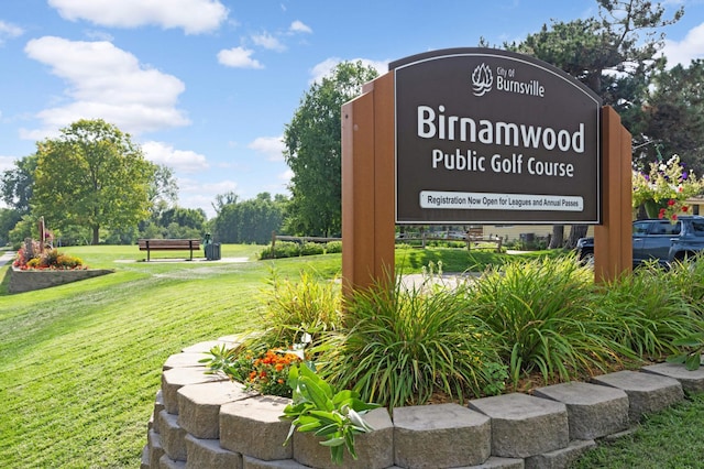 community / neighborhood sign with a lawn