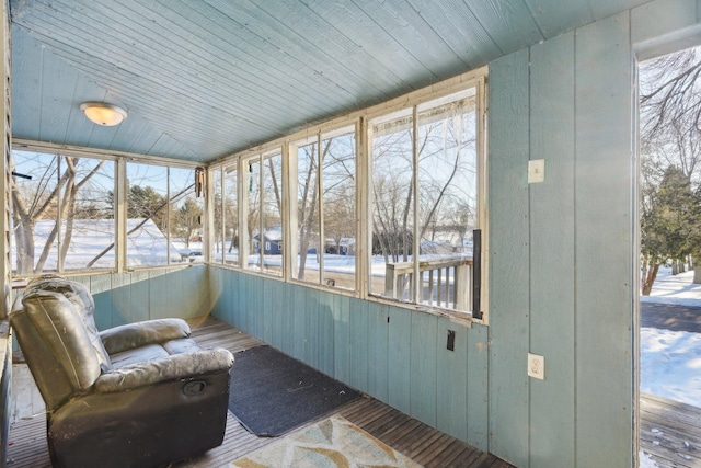 sunroom featuring wooden ceiling and plenty of natural light