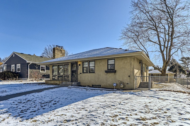 view of snow covered rear of property