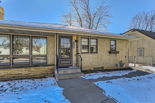 view of snow covered property entrance