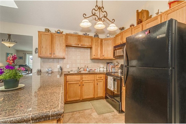 kitchen featuring black appliances, decorative backsplash, sink, hanging light fixtures, and kitchen peninsula