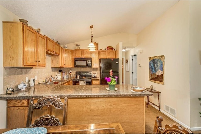 kitchen with black appliances, vaulted ceiling, kitchen peninsula, and tasteful backsplash