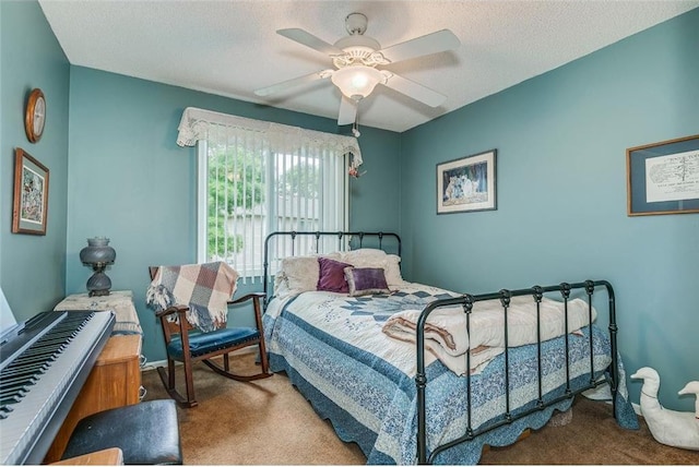 bedroom with ceiling fan, a textured ceiling, and carpet