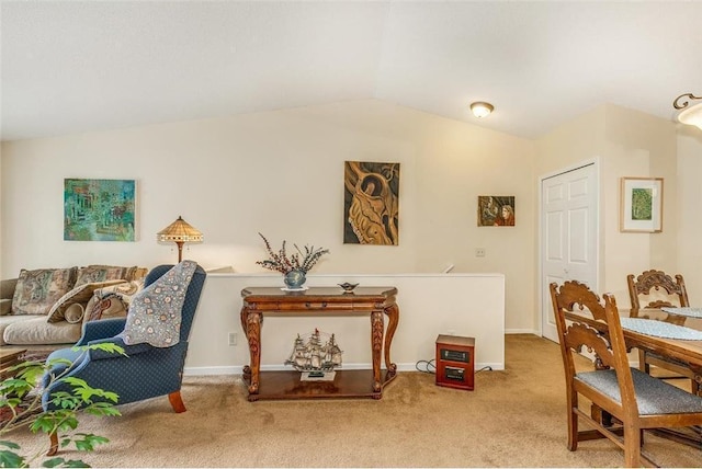 living area with vaulted ceiling and light colored carpet