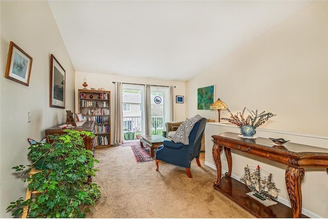 sitting room featuring carpet flooring and lofted ceiling