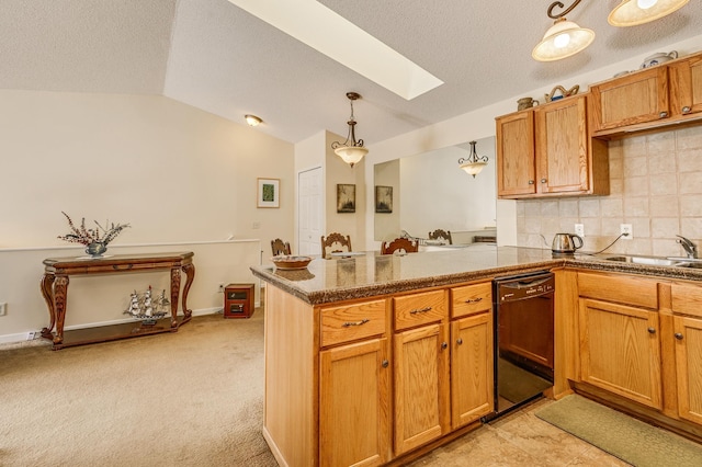 kitchen with sink, hanging light fixtures, lofted ceiling with skylight, black dishwasher, and kitchen peninsula