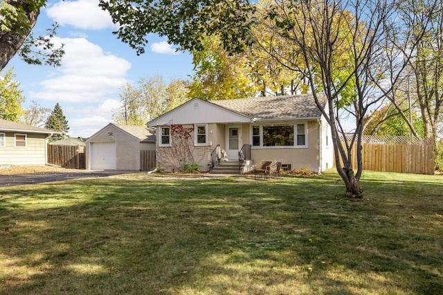 ranch-style home featuring an outbuilding, a front lawn, and a garage