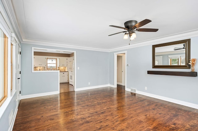 spare room with ceiling fan, ornamental molding, and dark wood-type flooring