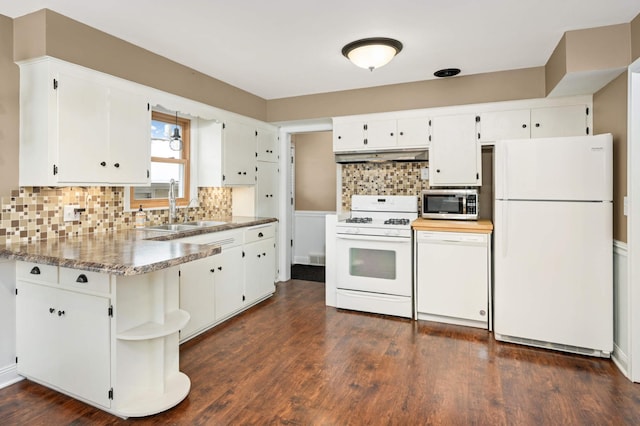 kitchen featuring sink, white appliances, and white cabinets