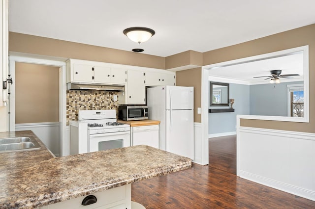 kitchen with white cabinetry, dark hardwood / wood-style flooring, white appliances, tasteful backsplash, and ceiling fan