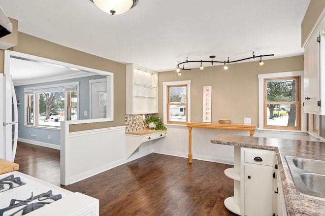 kitchen with white cabinetry, white refrigerator, and a healthy amount of sunlight