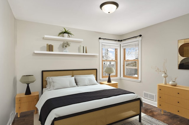 bedroom with dark hardwood / wood-style floors