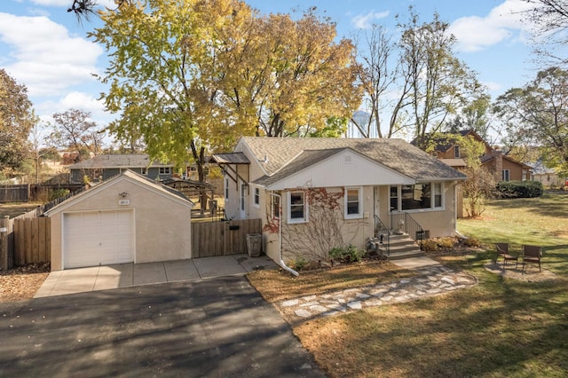 view of front of house with a garage, an outbuilding, and a front yard