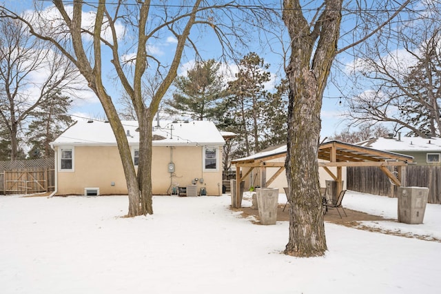 snow covered property with central air condition unit