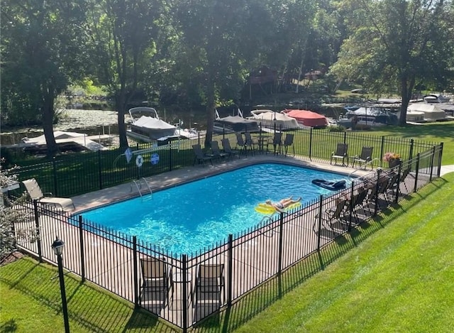 view of pool featuring a lawn