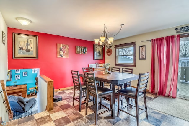 dining space featuring a wealth of natural light and an inviting chandelier