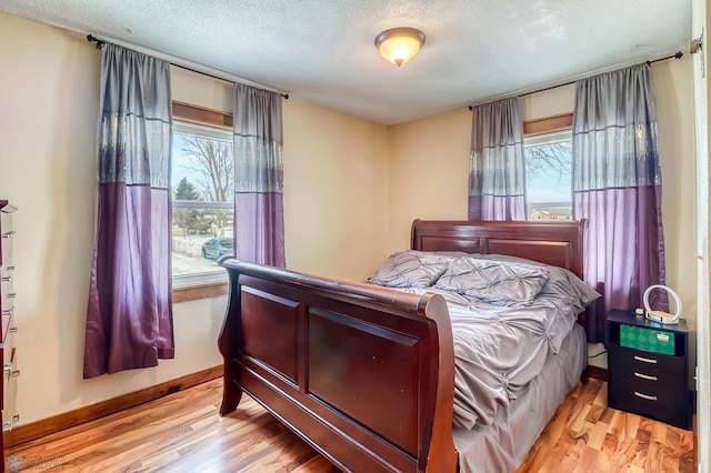 bedroom featuring a textured ceiling and light wood-type flooring