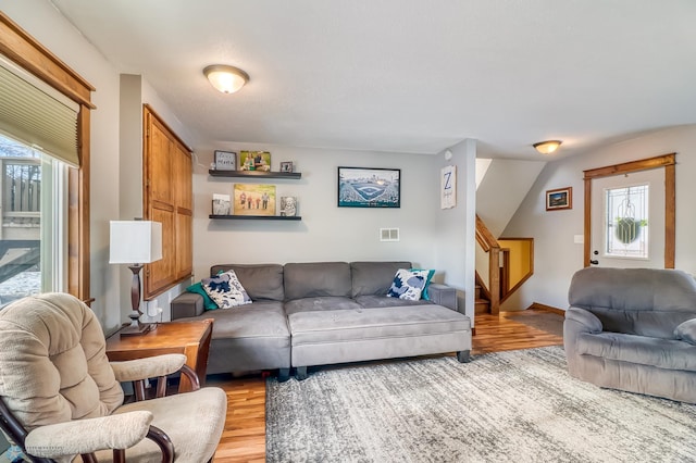 living room with plenty of natural light and light hardwood / wood-style flooring