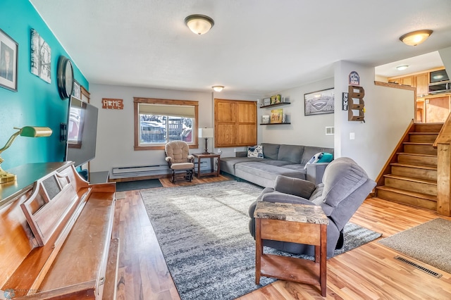 living room featuring hardwood / wood-style flooring and a baseboard heating unit