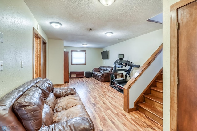 living room with hardwood / wood-style floors and a textured ceiling