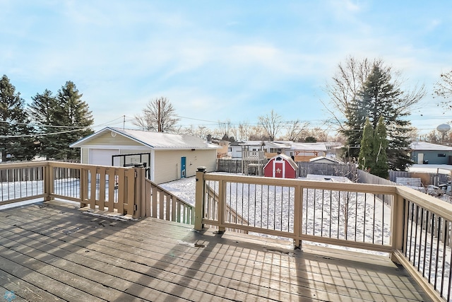 wooden terrace featuring a garage and a storage unit