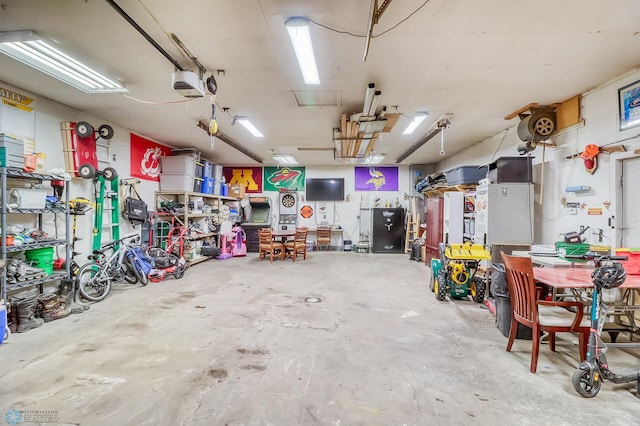 garage featuring a garage door opener and a workshop area