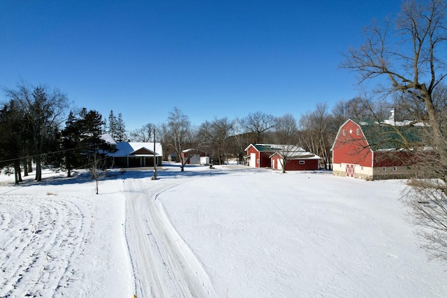 yard layered in snow with an outbuilding