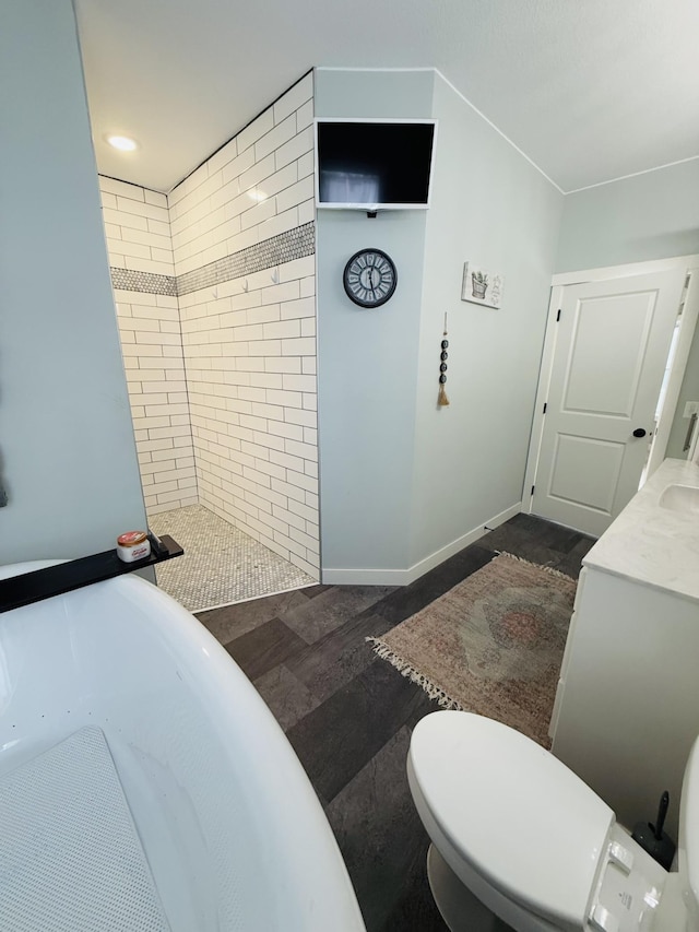 bathroom featuring tiled shower and toilet