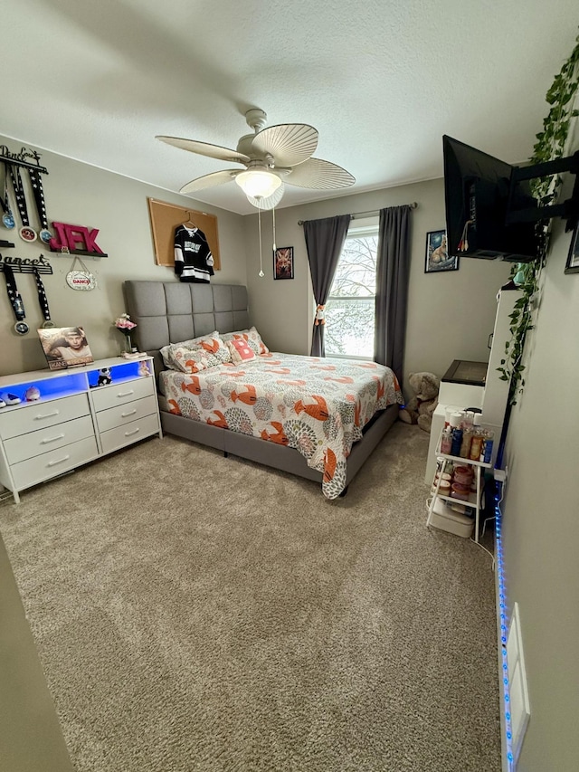 carpeted bedroom with a textured ceiling and ceiling fan