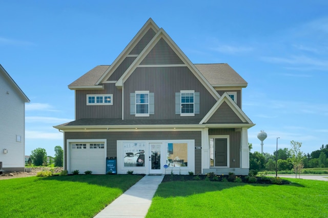 craftsman-style house featuring a garage and a front yard