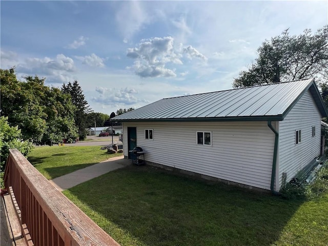 view of property exterior featuring a lawn