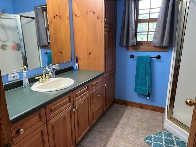 bathroom with vanity, a shower with shower door, and tile patterned flooring