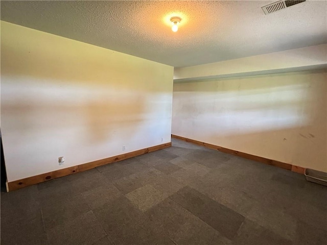 spare room with a textured ceiling