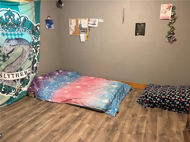 bedroom with wood-type flooring