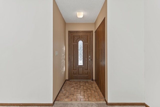 entryway featuring a textured ceiling