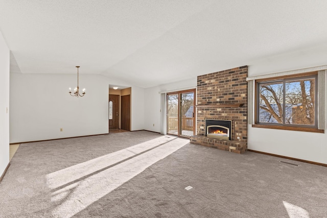 unfurnished living room with lofted ceiling, carpet flooring, a chandelier, and a fireplace