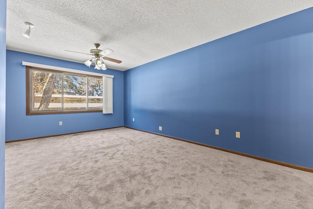 spare room with ceiling fan, carpet floors, and a textured ceiling