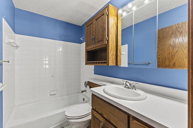 full bathroom with washtub / shower combination, vanity, toilet, and a textured ceiling