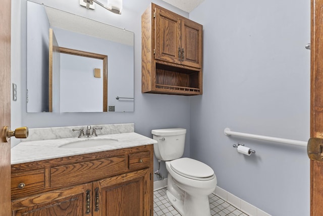 bathroom with vanity, tile patterned floors, and toilet