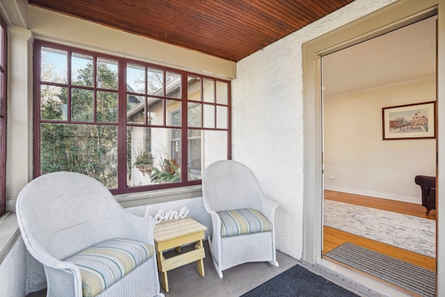 sitting room with wooden ceiling and hardwood / wood-style floors