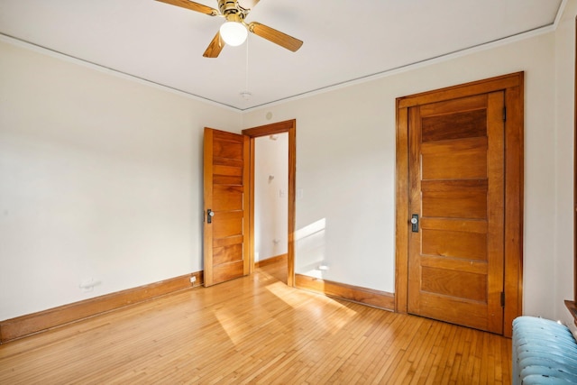 unfurnished bedroom featuring ceiling fan, radiator, and light hardwood / wood-style floors