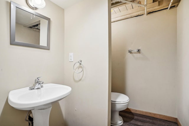 bathroom with wood-type flooring and toilet